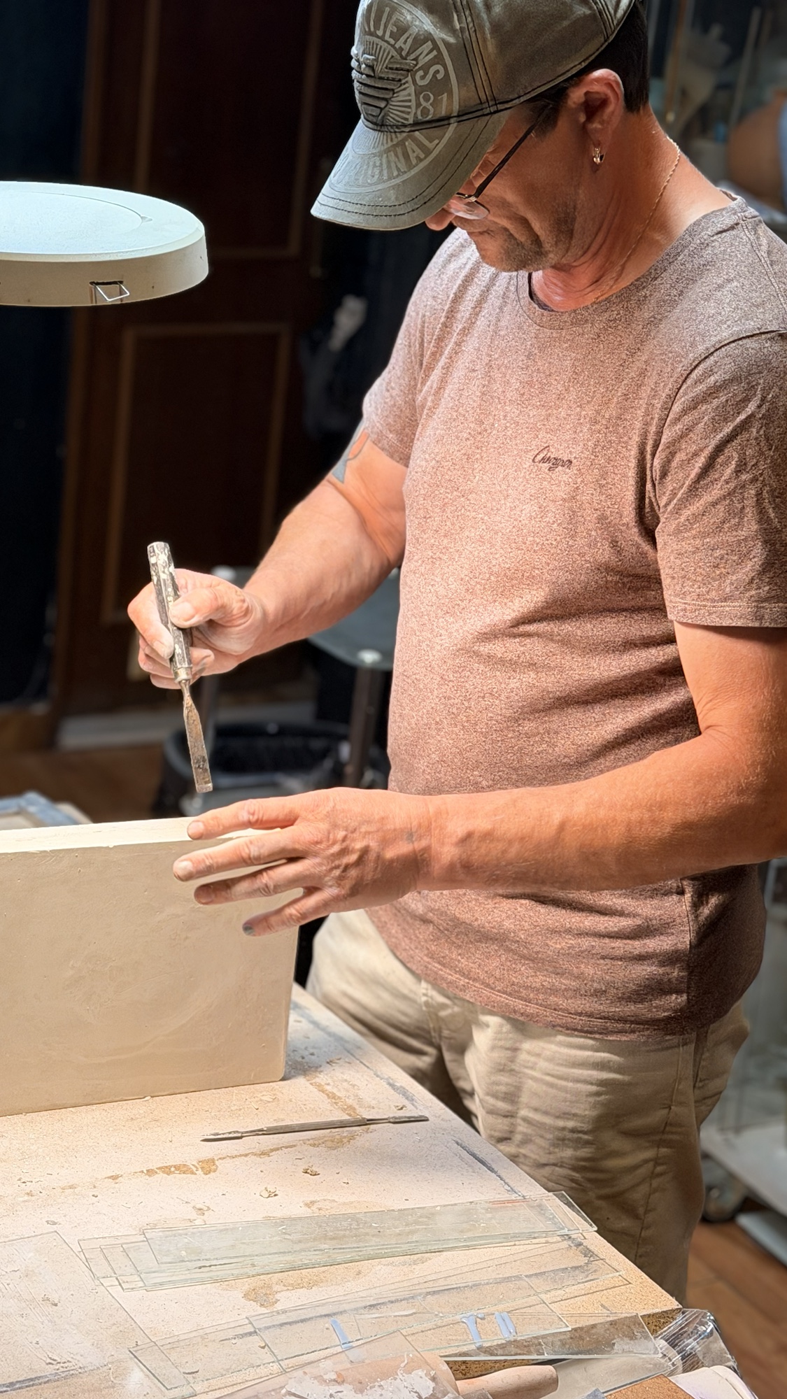 Vitaliy Manech shaping a ceramic work by hand in his studio